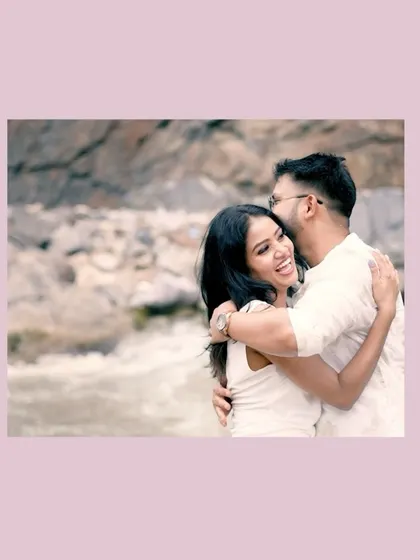 A candid, joyful moment as a couple hugs by the river, their laughter making for a perfect, natural shot.