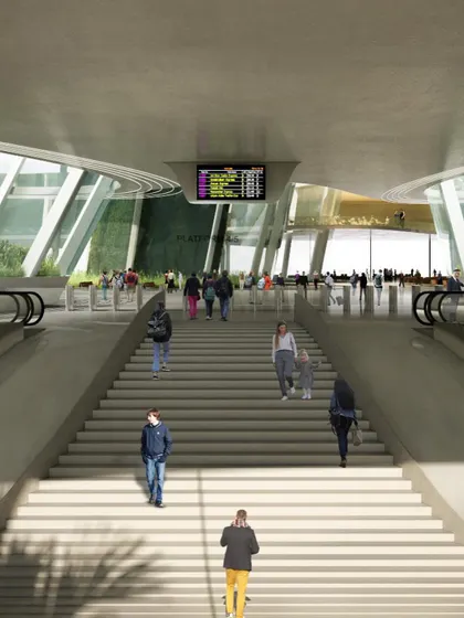 The main staircase provides a grand entrance to the concourse level, with escalators on either side for accessibility.