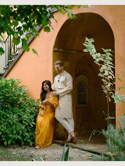 A serene couple portrait during their Haldi event at Isola del Garda, Italy. The lush greenery and historic architecture provide a stunning backdrop.