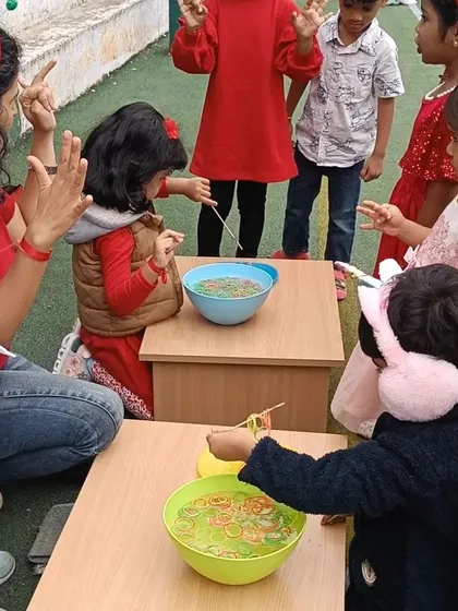 A fine motor game of fishing for rubber bands with a stick. This activity requires immense focus and hand-eye coordination, cleverly disguised as a fun Christmas game.
