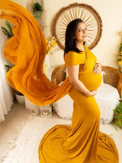 A beautiful fabric toss with the yellow gown, creating a sense of movement and grace.