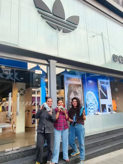 Posing with happy customers and their newly customized sneakers outside the Adidas store. Seeing people excited to wear my art is the best part of these live activations.