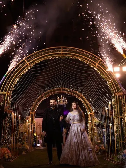 A grand entrance for the couple through a tunnel of light, with guests holding cold pyro sparklers. This creates a spectacular, high-energy welcome for the newlyweds at their reception.