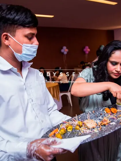 A member of our team serving appetizers from a platter. This image captures the professionalism and attentiveness of our service staff.