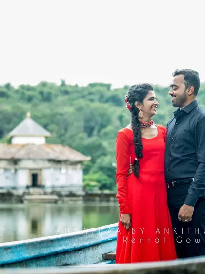 A close-up of the couple in the boat. The simple, elegant design of the gown ensures that the focus remains on the couple's connection and happiness.