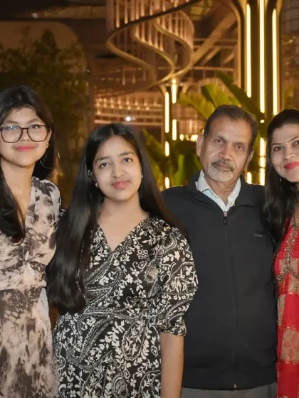 A four-person family group photo at an evening event. We are experienced in posing and lighting groups to ensure everyone looks their best.