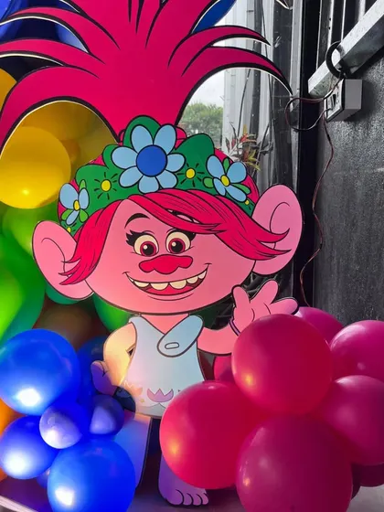 A large, detailed cutout of Poppy from Trolls, used as a key decorative element.
