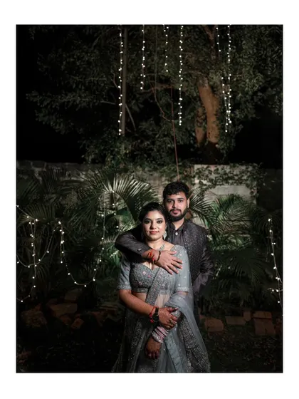A beautiful night portrait of the couple, surrounded by twinkling fairy lights that create a magical ambiance.