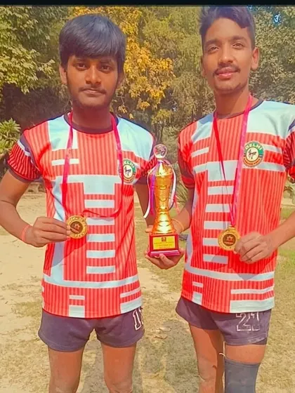 Two of our champions with their gold medals and the winner's trophy. Their hard work has paid off.