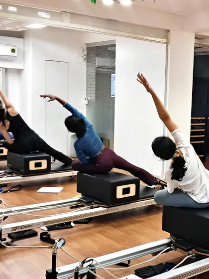 A beautiful side-body stretch on the reformer box, this move helps improve flexibility and release tension in the obliques and spine.