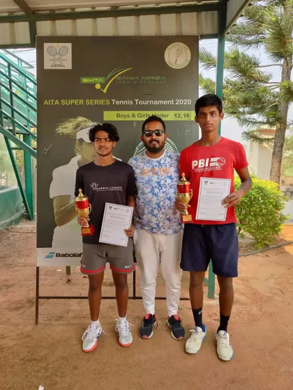A coach with the doubles finalists, a proud moment recognizing the hard work of these young athletes.
