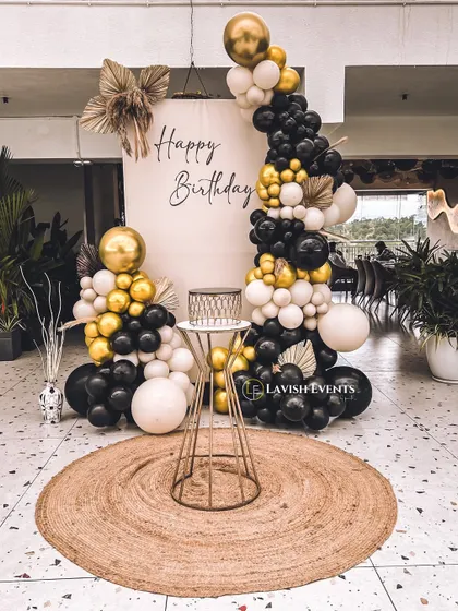 A bold black, white, and gold balloon arrangement for a modern and chic birthday party.