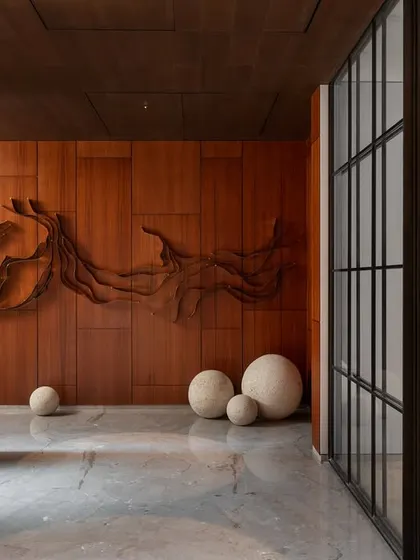 Upon entering, a custom-designed, three-dimensional wooden art piece serves as a powerful focal point, demonstrating a commitment to integrating art directly into the architecture.