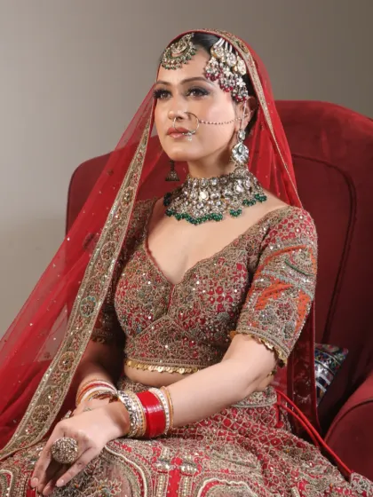 Every bride deserves to feel beautiful on her big day. This bride is glowing in her red lehenga, with makeup that enhances her natural beauty and joy.