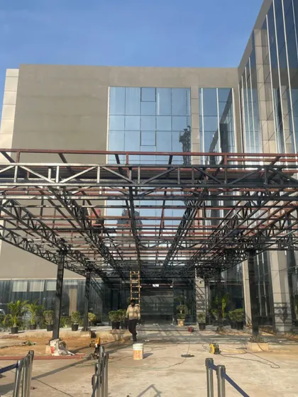 Work in progress at Heritage Xperiential School. This image shows the structural framework of the entrance canopy, offering a glimpse of the building's skeleton before the final layers are applied.