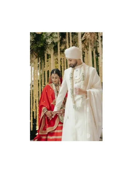 A classic, framed shot of Avin and Nikki during their ceremony, capturing the solemnity and beauty of the moment.