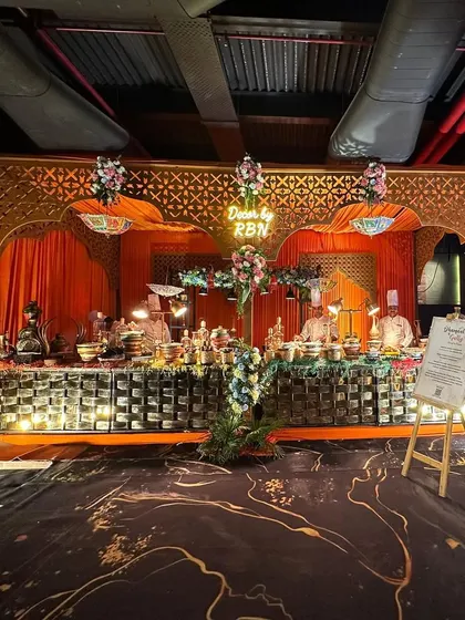 This is a wide view of my Indian food stall at The Gourmet Fest. The setup features ornate arches and floral decor, creating a royal setting for the traditional delicacies on offer.