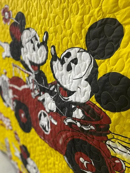 A detail shot of the Mickey and Minnie quilt, showing the pebble-like quilting pattern.