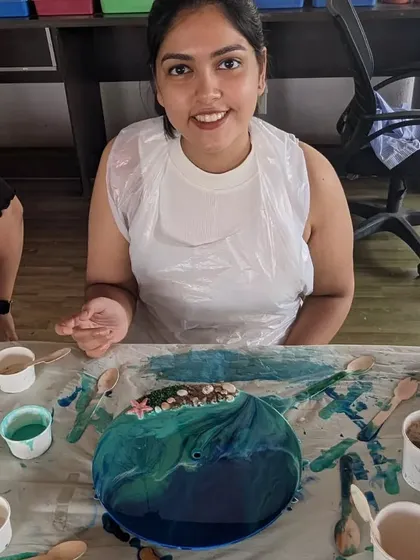 A participant fully absorbed in creating her resin beach art. Our workshops provide a perfect escape to focus on creativity and make something beautiful with your hands.