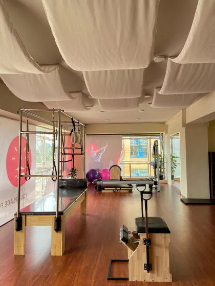 Another perspective of our equipment area, highlighting the Cadillac machine. This versatile apparatus is excellent for stretching, strengthening, and improving spinal mobility.