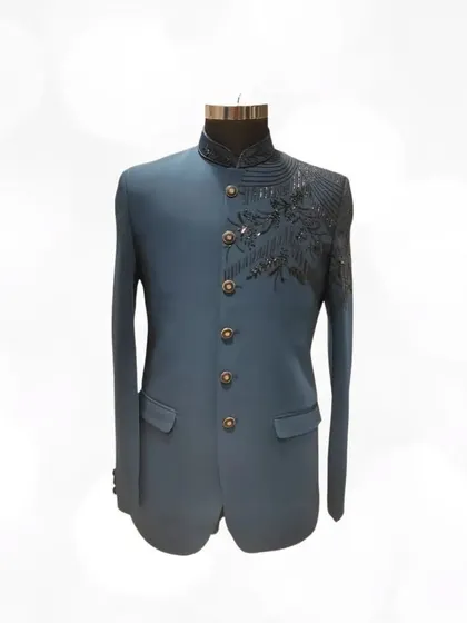 This teal Jodhpuri suit with asymmetrical black sequin work is for the man who isn't afraid to make a style statement. Find bold designs like this in our pre-loved collection.