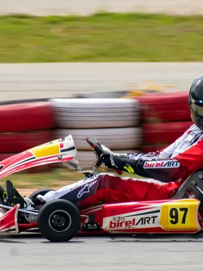 Our driver Muktak Joshi in kart number 97, demonstrating perfect form through a corner. The kart is an extension of the driver, and we ensure a perfect fit and setup.