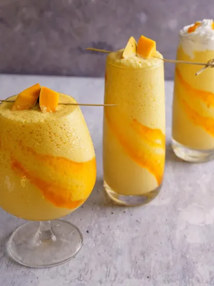 A trio of mango smoothies, each with a slightly different style. This shot is great for showing the variety available on a seasonal menu.