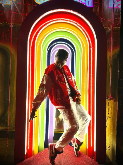 Striking a pose in the rainbow tunnel. This shot is all about confidence, style, and owning the spotlight.
