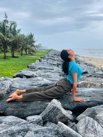 Practicing Urdhva Mukha Svanasana, or upward facing dog, on the coastal rocks. This heart-opening pose feels even more expansive when you're breathing in the fresh sea air.