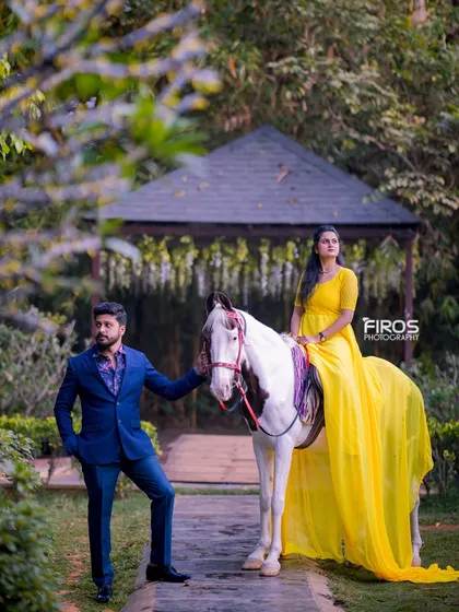 A majestic portrait of a couple with a beautiful white horse. This is a perfect shot for creating a truly grand and memorable pre-wedding album.