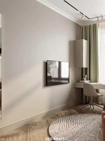 This angle shows the room's layout, including the wall-mounted TV and the circular rug that adds a soft, graphic element to the herringbone wood floor.