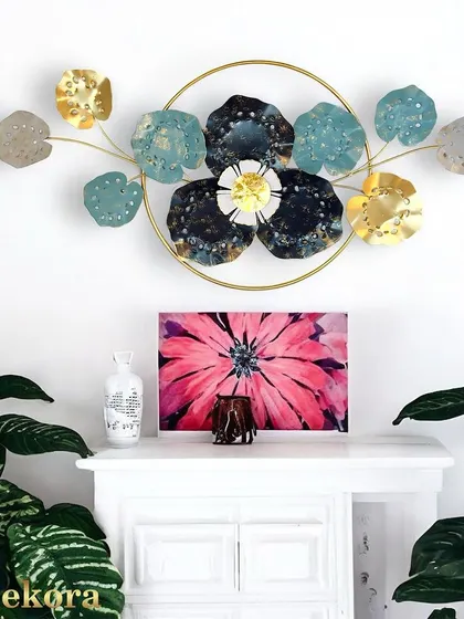 A circular floral arrangement with blue, black, and gold flowers. The ring frame ties the composition together, making it a modern and cohesive piece.