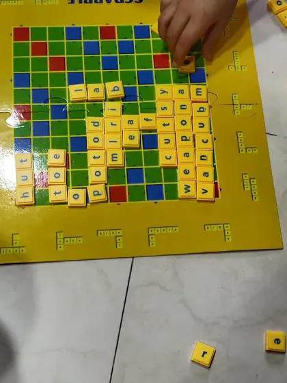 A close-up of our Scrabble game in progress. You can see how we form a web of words, encouraging strategic thinking.