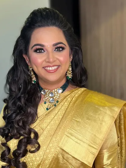 A stunning engagement bride in a golden saree. I created a soft smokey eye and styled her hair in classic curls for a timeless and elegant look.