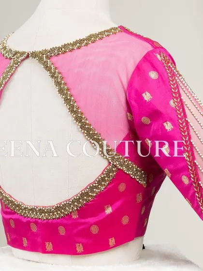 A closer look at the craftsmanship of this pink pure silk blouse. It features intricate handwork with bead detailing on the neckline and delicate net sleeves with linear embroidery for a touch of grace.