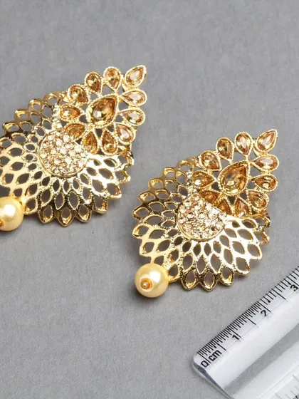 Another view of the golden filigree earrings, showing the beautiful craftsmanship.