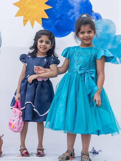 Best friends in blue. This image showcases two different styles in shades of blue, one in a classic navy and the other in a bright turquoise tulle, showing the variety in my party dress collection.