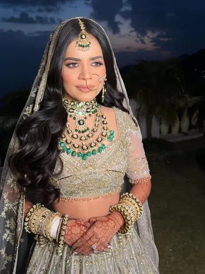 A beautiful shot of the bride at dusk, her simple yet elegant hairstyle looking perfect for her outdoor wedding.