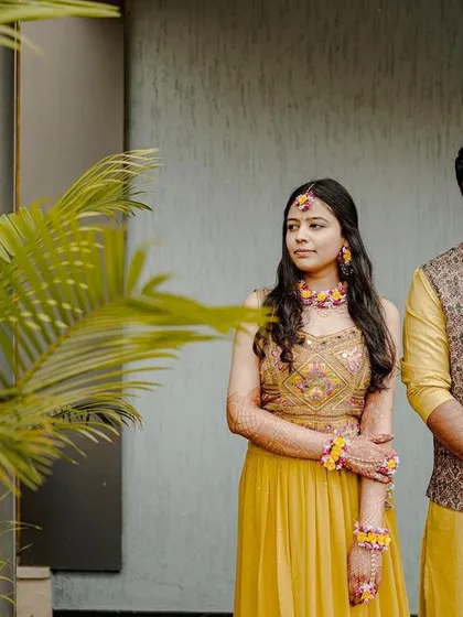 A classic portrait of the couple looking poised and happy during their Haldi ceremony.