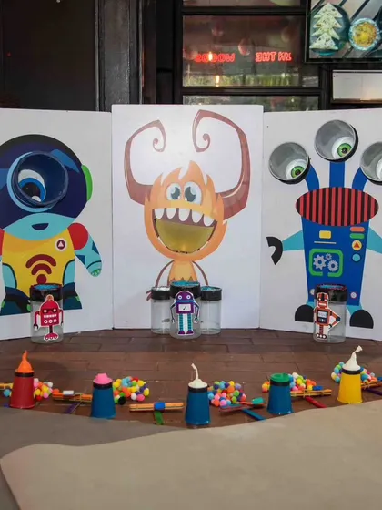 Our monster-themed activity station is ready for action. We set up these colorful, interactive games where kids can feed the monsters, play, and learn simple physics concepts all at once.