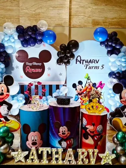 A classic Mickey Mouse theme is always a great choice. This setup for Atharv's 5th birthday includes Mickey and his friends, themed backdrops, and fun props for a cheerful party.