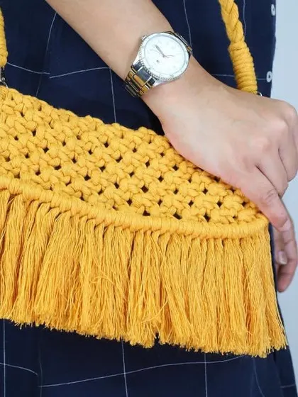 Bright and sunny! This yellow macrame sling bag with long fringes is perfect for a beach vacation or a summer day. It's handmade with so much care and good vibes.