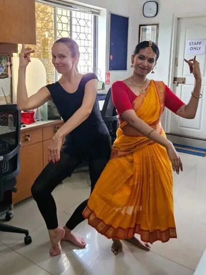 A fun moment where our ballet teacher, Ms. Iryna, tries her hand at a Bharatanatyam pose. It's a perfect example of our community's love for learning all forms of dance.