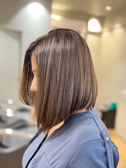 Less is more. These fine blonde highlights were added to blend and camouflage grey, creating a beautiful, cool-toned, and natural-looking result.