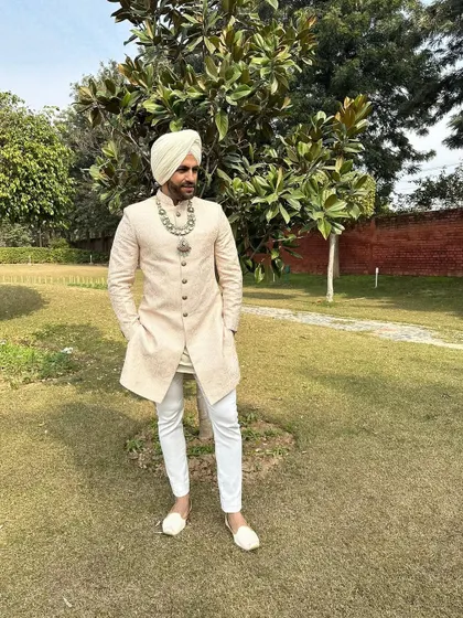 Another angle of the Sikh groom's look, showing the perfect fit of the sherwani and the statement jewellery.