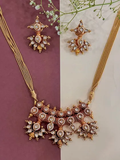 Crafted to perfection, this gold necklace set with polki diamonds tells a tale of elegance and grace. I believe in wearing your heritage with pride, and this piece allows you to do just that.