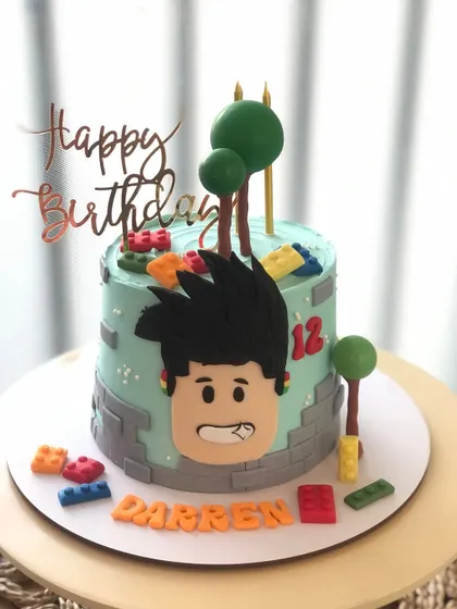 A fun Roblox-themed cake, featuring a character face and colorful building blocks.