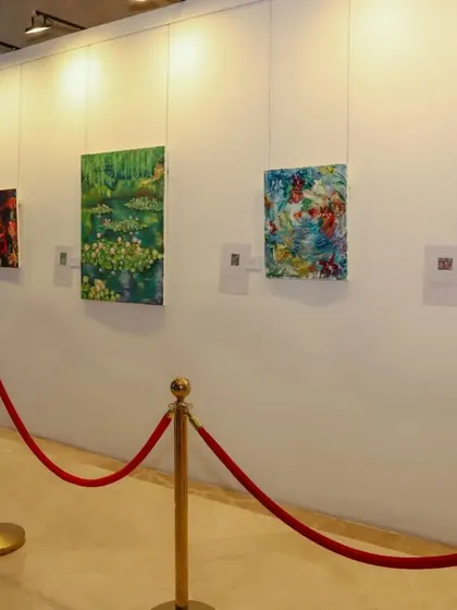 A gallery view of the Impressionism exhibition, with a red velvet rope guiding visitors.