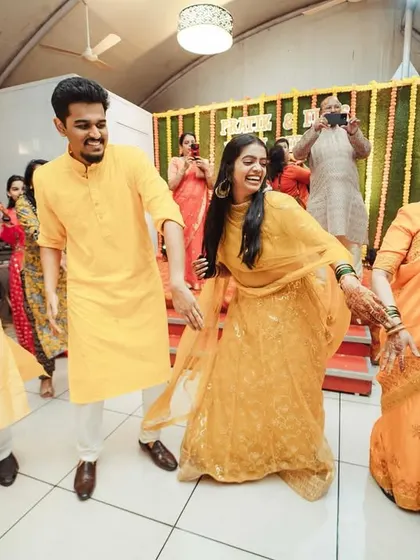 The entire family dancing together, a beautiful picture of unity and celebration at the Haldi ceremony.