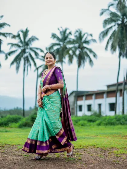 A classic, full-length bridal portrait, capturing the bride's confident and happy demeanor.